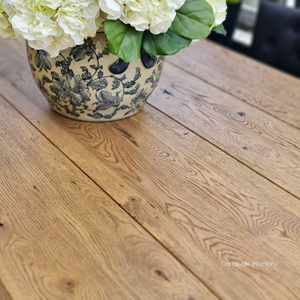 Close-up on the solid hardwood construction of the Treadstone Table, highlighting the rustic timber beams and craftsmanship.