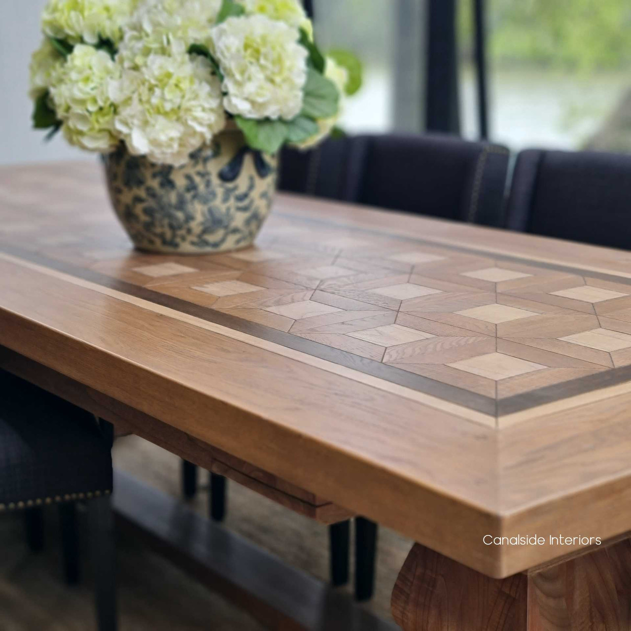 Side view of the Chambers Parquetry Dining Table, emphasizing the symmetry and beauty of the inlay work in a classical dining room