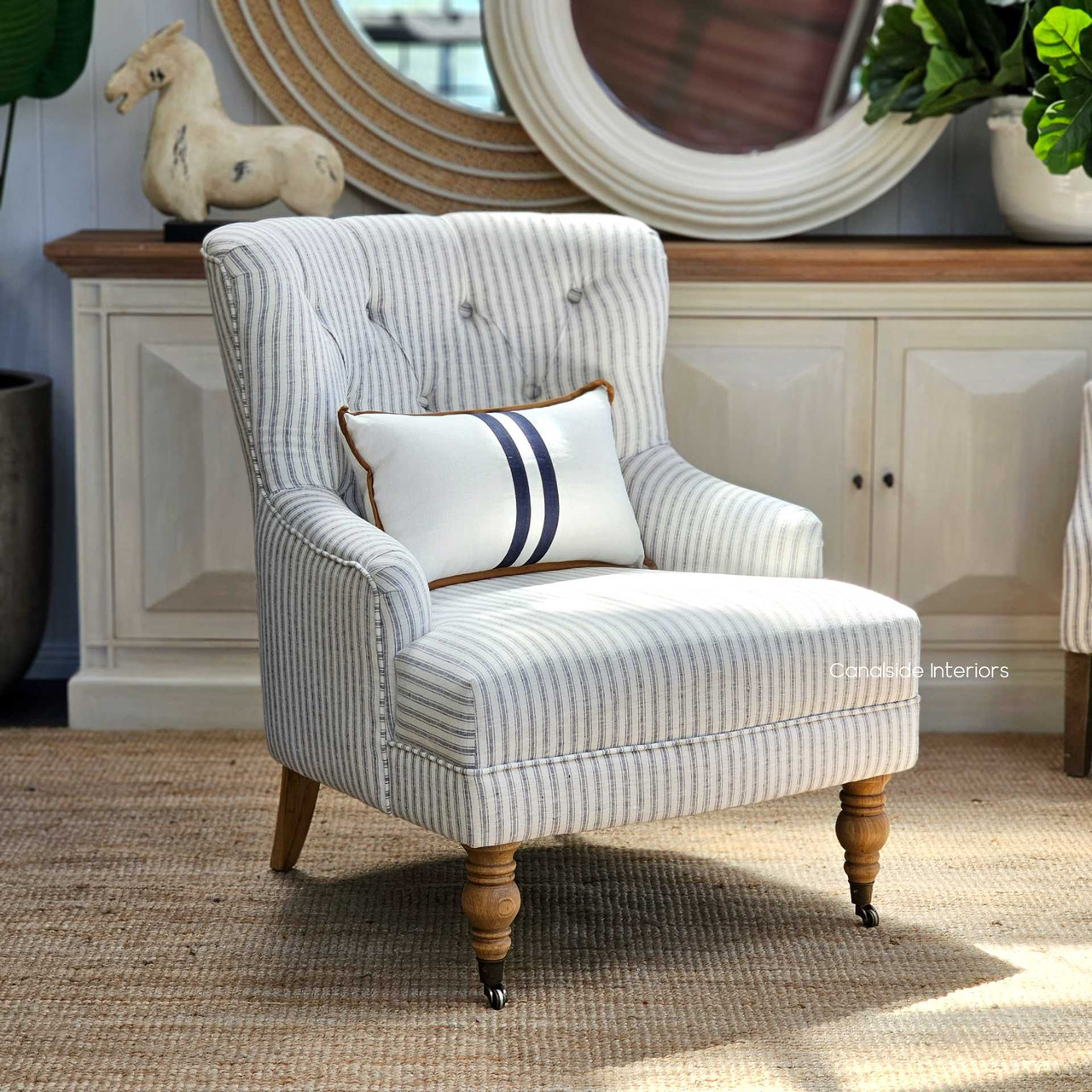The Ascott Armchair in a living room corner, inviting relaxation with its comfortable linen blend and stylish design.
