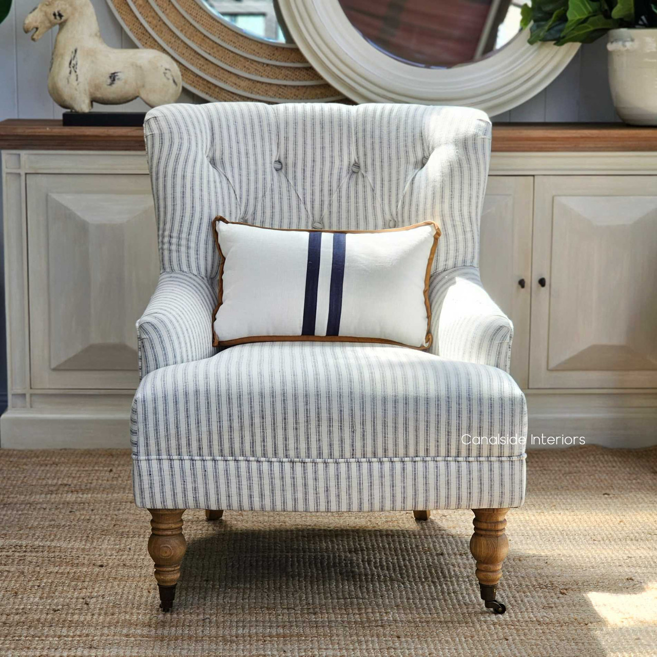 The inviting form of the Ascott Buttoned Armchair, positioned to add charm and sophistication to a cozy reading nook