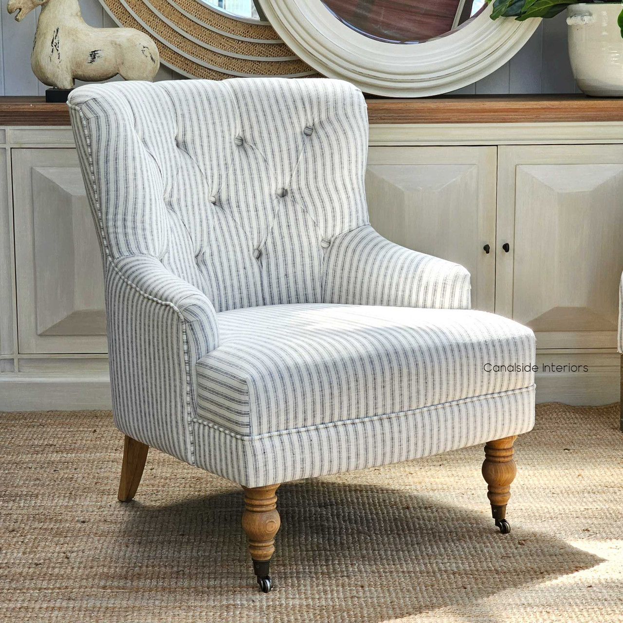 Detail of the Ascott Armchair's castor wheels, merging practicality with the chair's timeless coastal appeal.