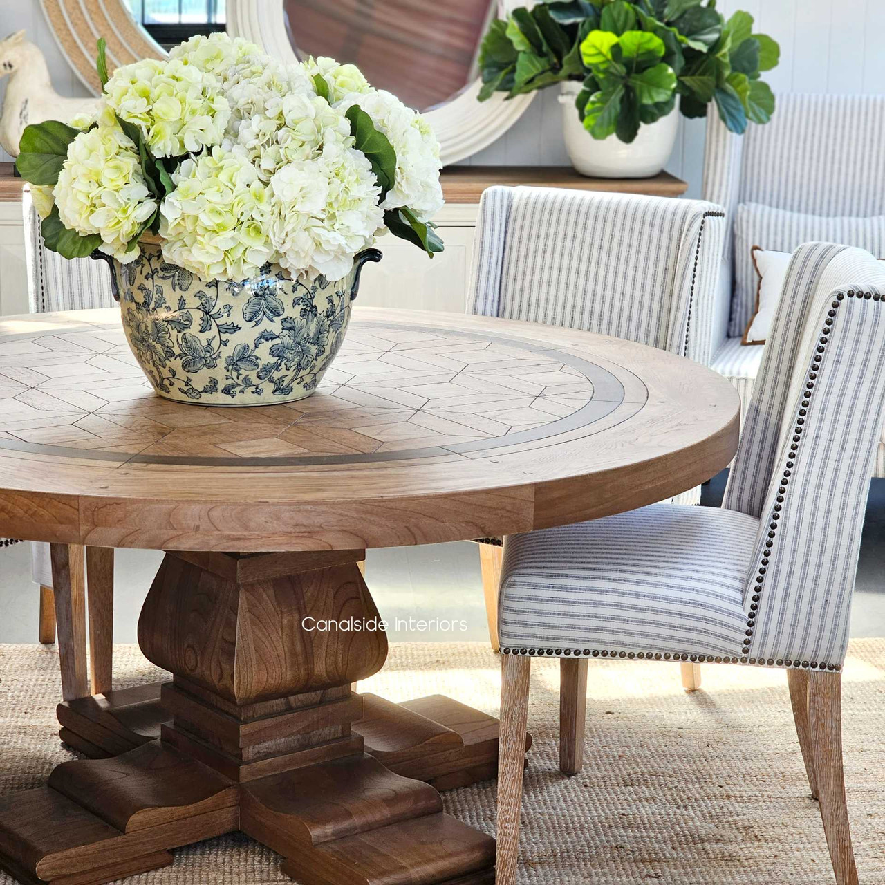 Detailed craftsmanship of the Chambers Round Dining Table's geometric inlay provides a stunning conversation piece for modern dining spaces