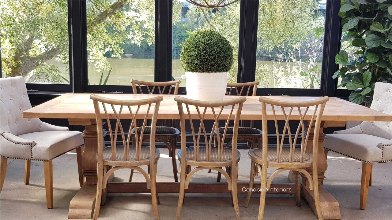 The Artisan Dining Table in a cozy nook, offering a perfect spot for morning coffee in a Hamptons-style bedroom