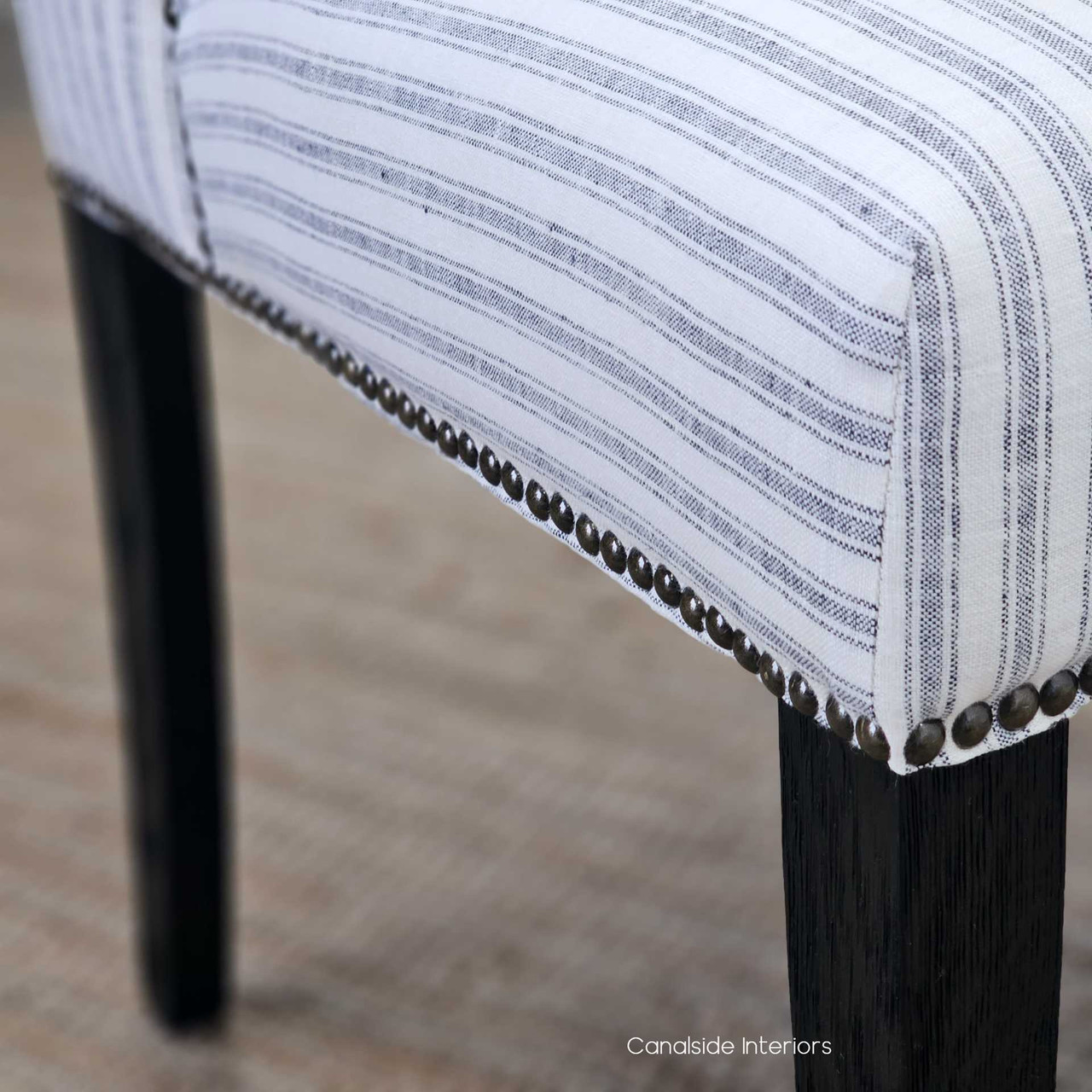 Detailed perspective of the Leclerc Chair's brass studs, accenting the quality craftsmanship ideal for a sophisticated office desk chair