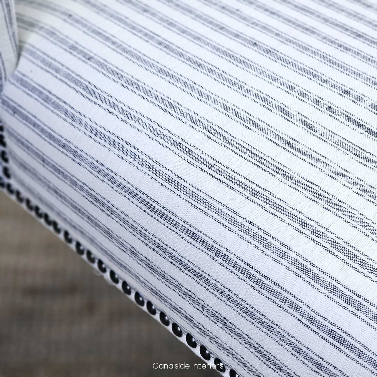 Detail shot of the Leclerc Chair's blue striped fabric, emphasizing the fine quality and coastal charm