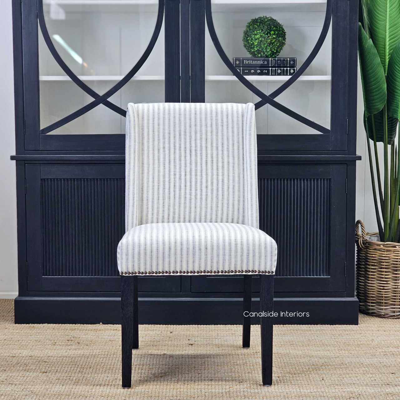 The Leclerc Dining Chair's black espresso oak legs, combining durability with a chic, space-saving design