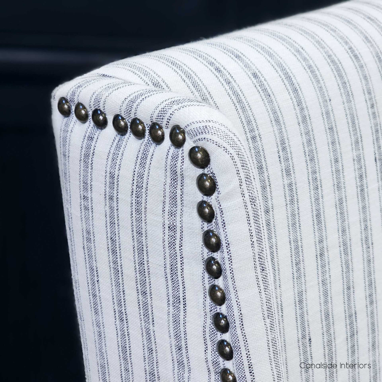 The subtle curves of the Leclerc Dining Chair's back, offering a comfortable embrace for extended dining experiences