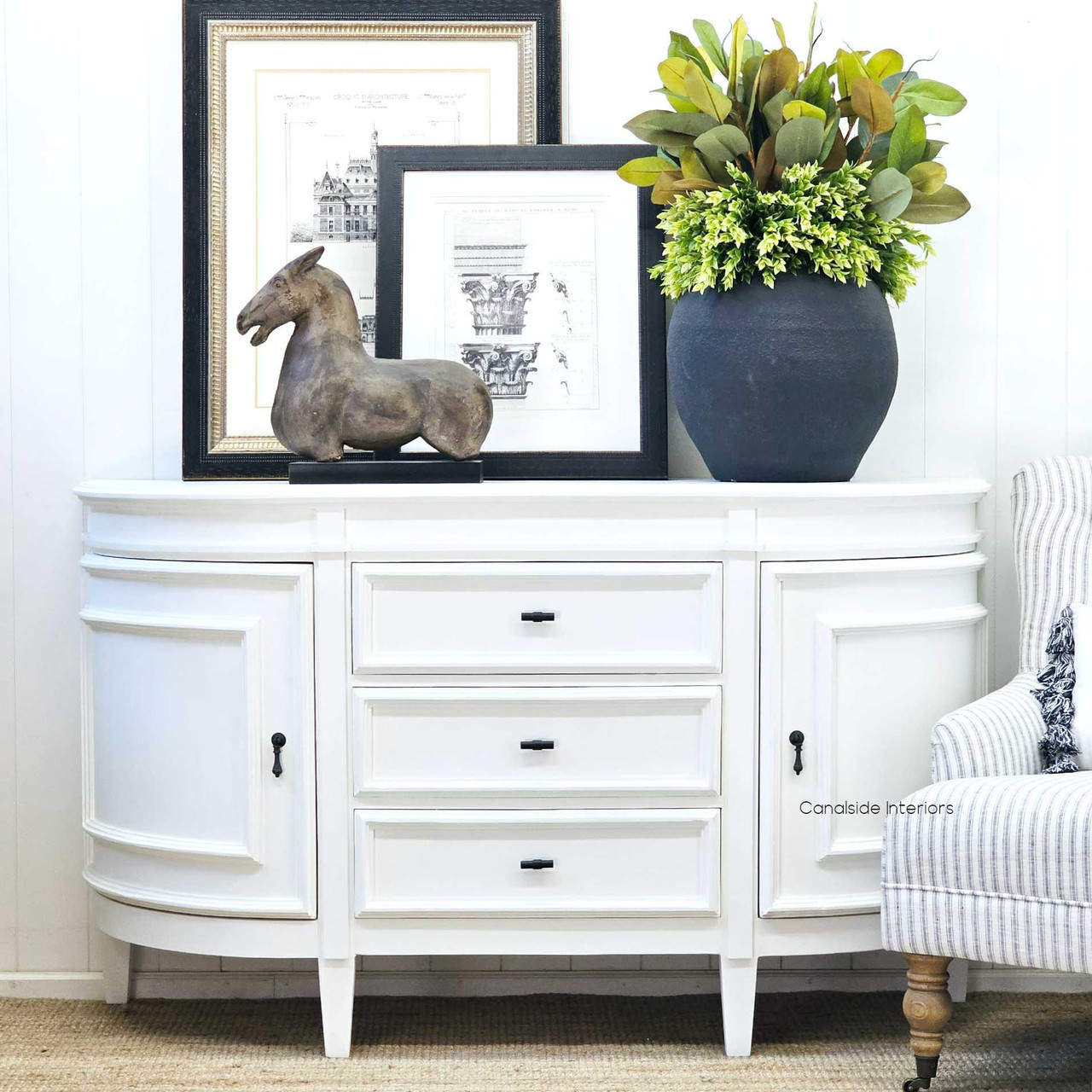 The Francia Petite Curved Sideboard in distressed white, a Canalside Interiors piece blending Hamptons luxury with modern living room design