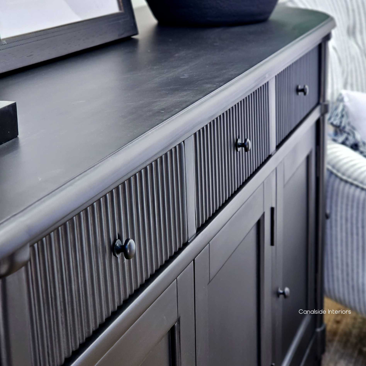 The distressed black finish of the French Louis Buffet Grande, offering timeless storage for living room essentials in Sydney's stylish interiors.