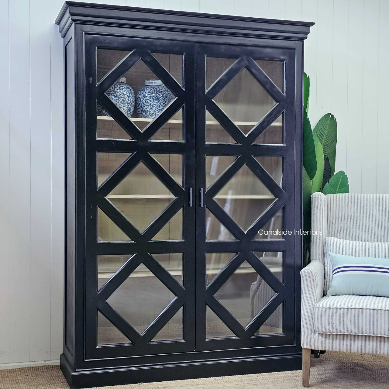 The elegant cross door pattern of the Tunbridge Cupboard in distressed black, embodying the classic beauty characteristic of Canalside Interiors