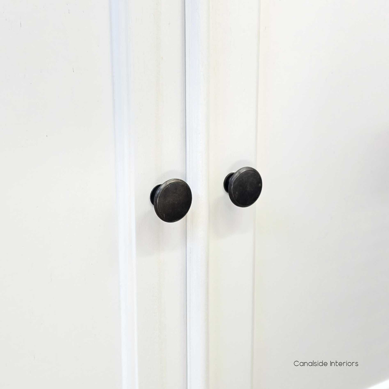 Close-up of the hand-finished patina on the Casement Media Unit, highlighting the unique craftsmanship and quality