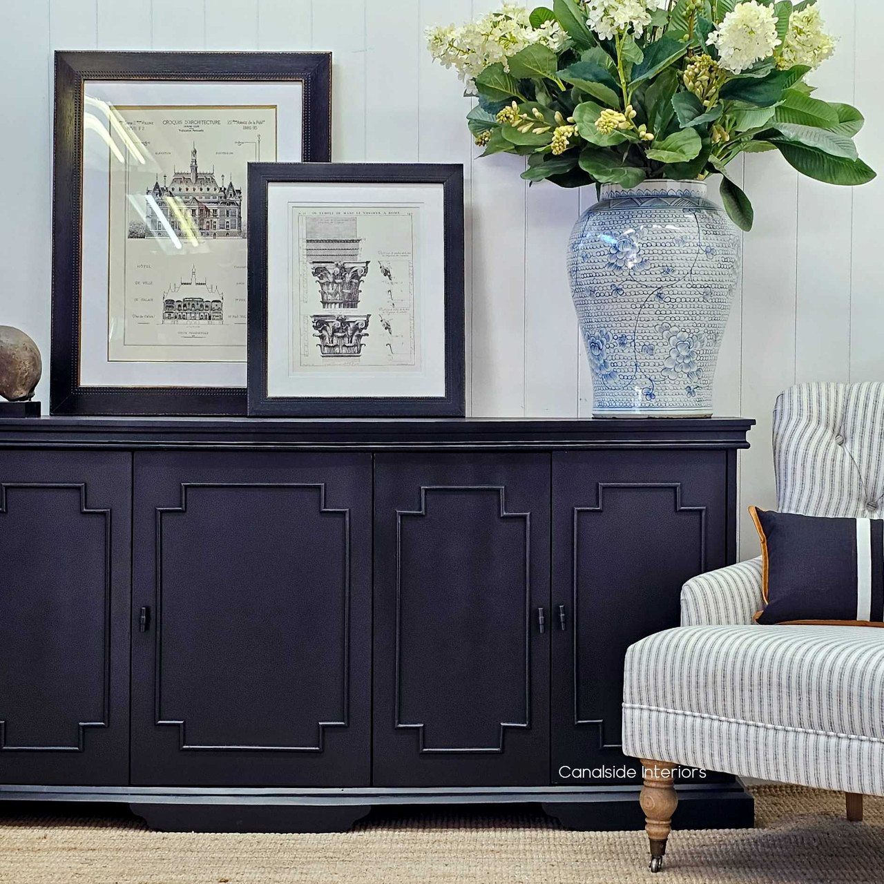 The charcoal Leontine Sideboard's detailed trim work, captured from the front, offering a chic solution for home office organization