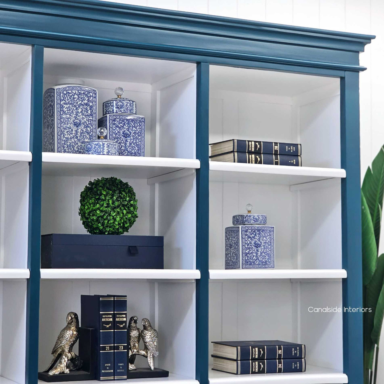 Perspective shot of the Grange Wall Unit's white interior shelves, emphasizing the unit's modern functionality and coastal charm