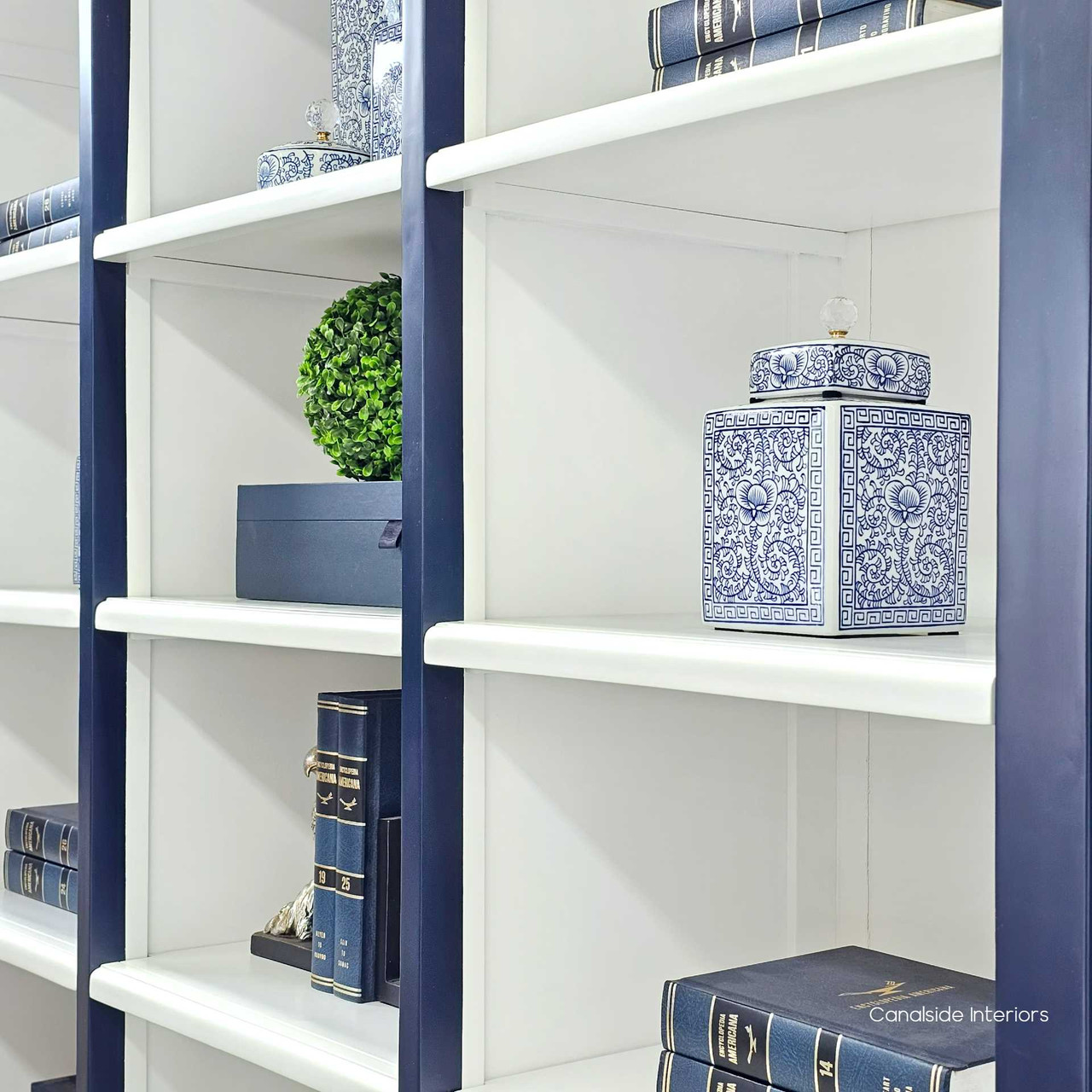 Close-up of the white interior shelving within the navy blue Grange Wall Unit, displaying timeless design | Coastal Chic