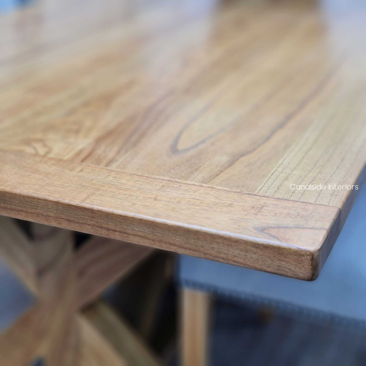 Close-up on the Harvest Dining Table's smooth white cedar surface, reflecting relaxed living and timeless quality.