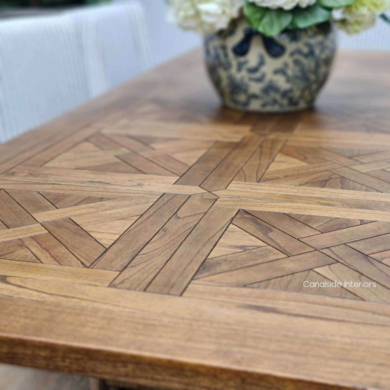 Close-up of the Stamford Table's hand-crafted parquetry, highlighting the detailed work and textural finish
