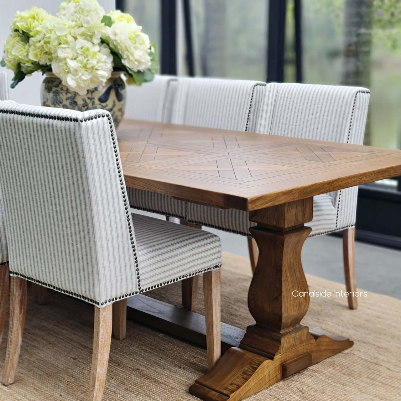 Side view of the table in a contemporary setting, showcasing how it complements modern decor with its classical elements.
