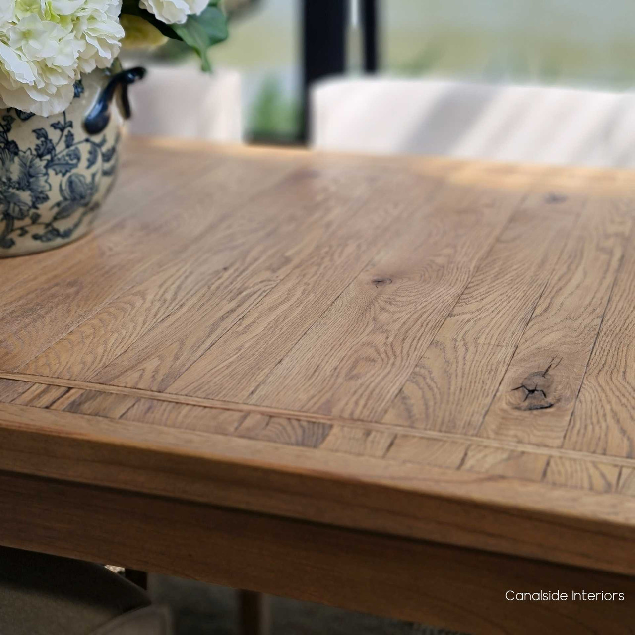 The Hayworth table amidst a chic, coastal-themed dining area, highlighting its versatility and aesthetic appeal.