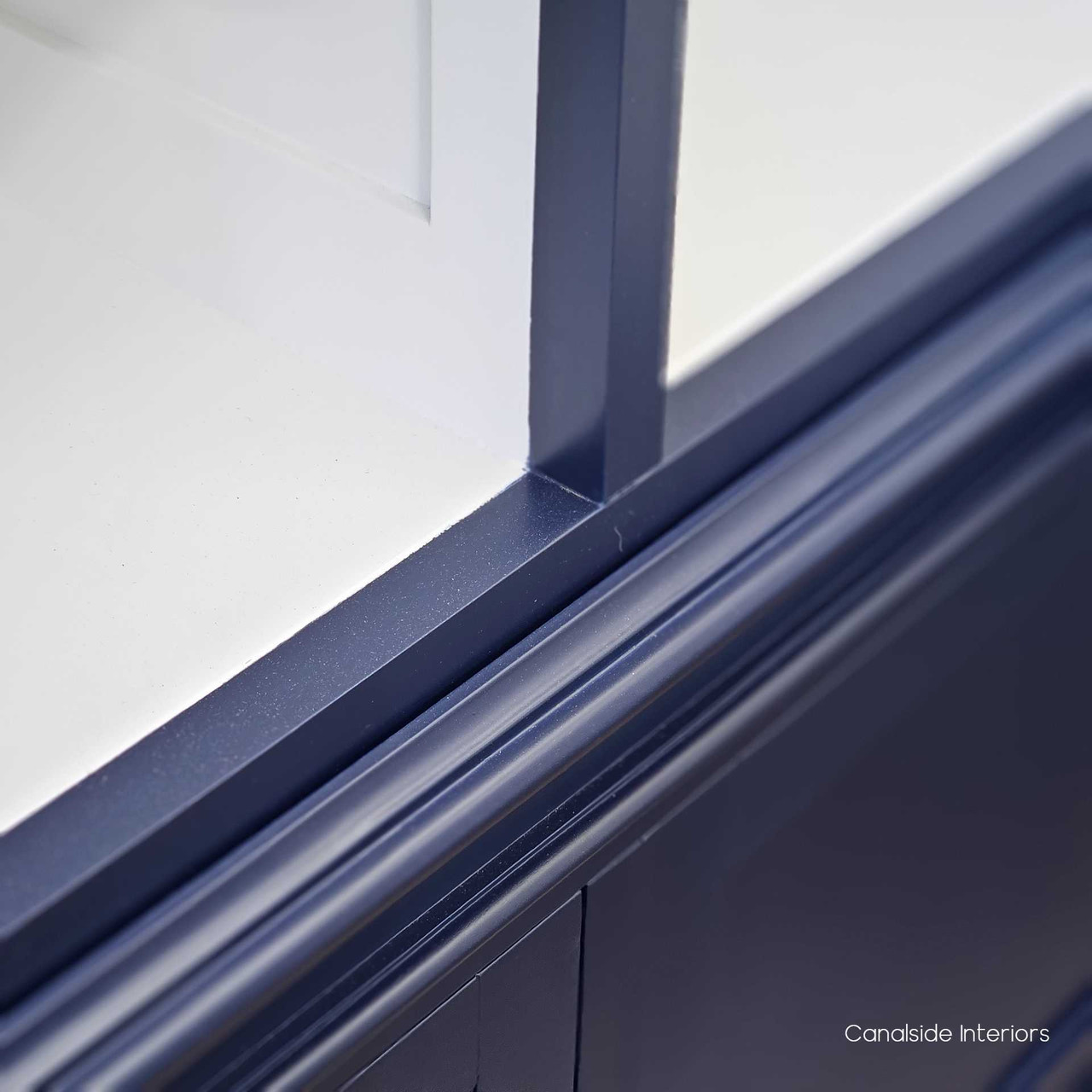 Baseboard close up displaying the baseboard of the unit, emphasising the stability and robust design of the Grange Wall Unit and navy finish