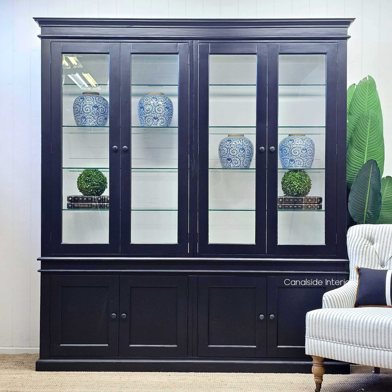 Presenting the Grange Glass Door Display Wall Unit from a straight-on view with the glass doors closed, highlighting the sleek and unified appearance of the black finish with white interior.