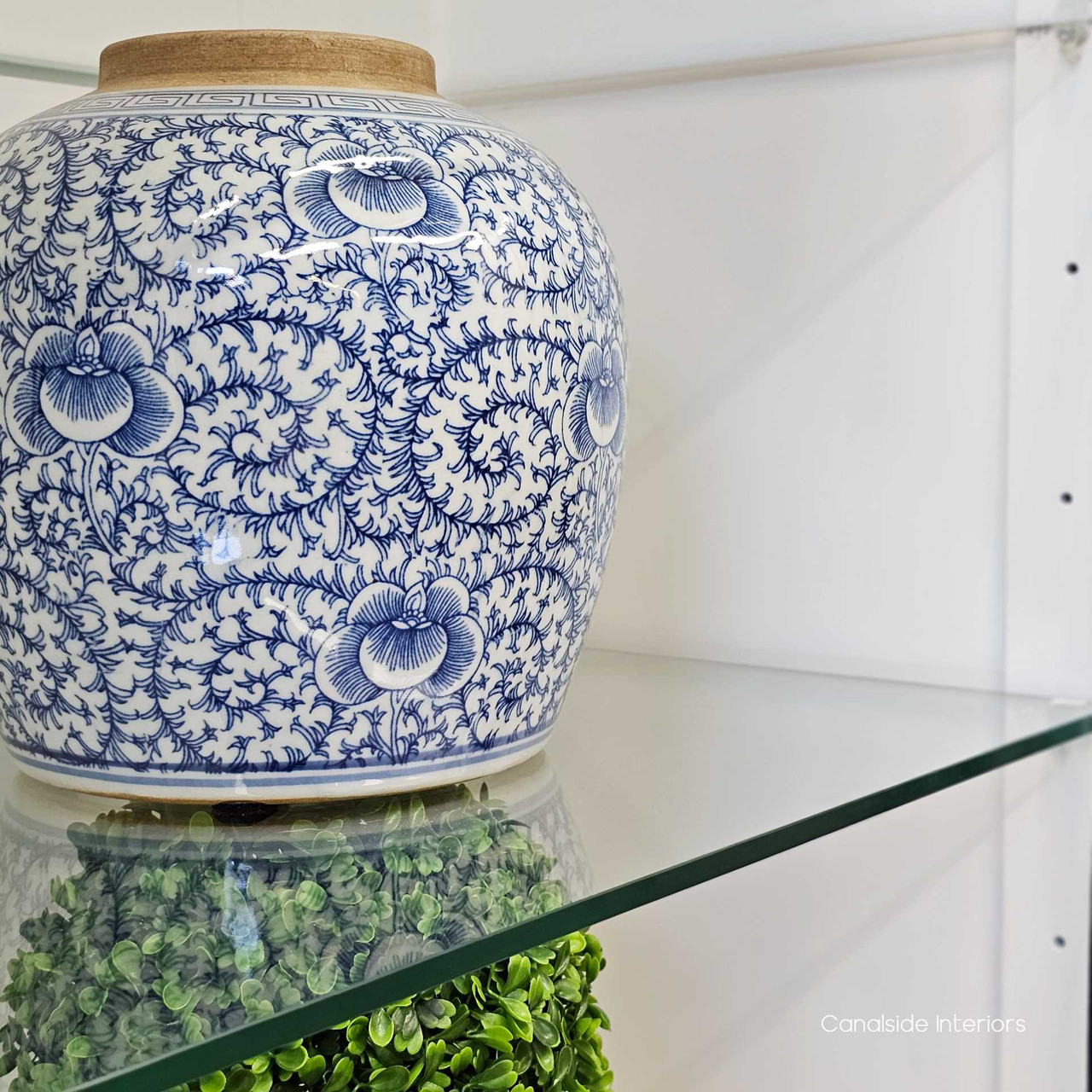 Focus on the glass shelves, highlighting their clarity and the ample space they provide for elegant display.