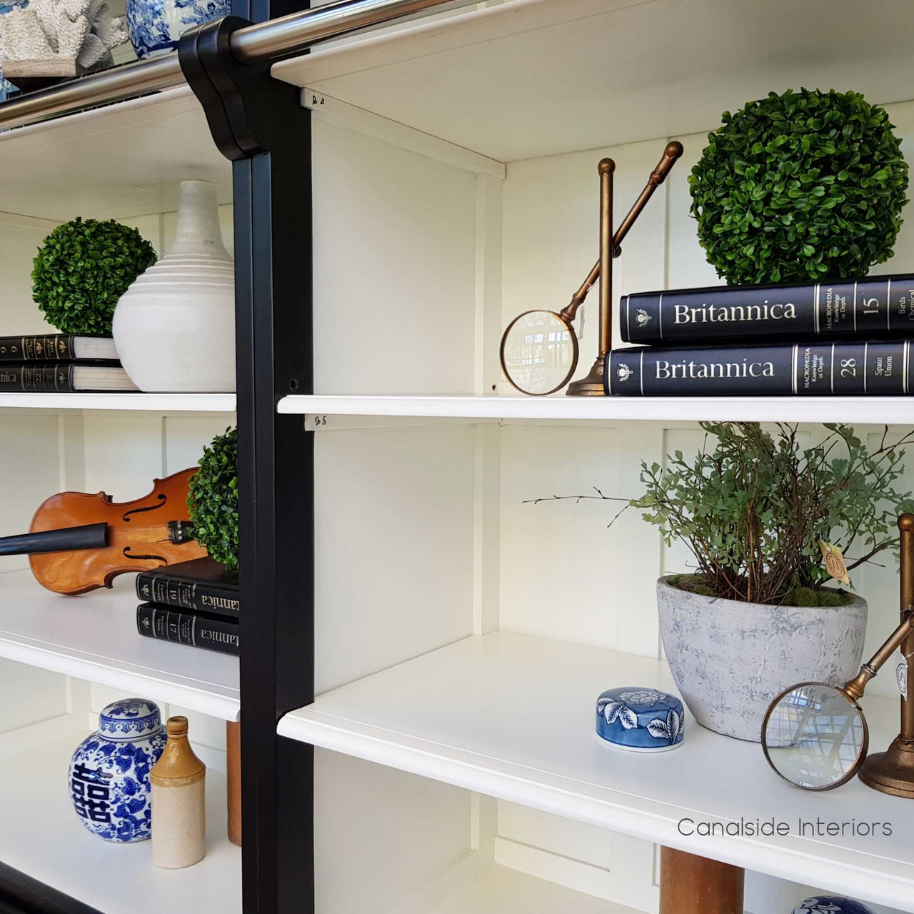 Achieve a French Provincial haven with the distressed black exterior and white shelving of this exquisite Grange bookcase