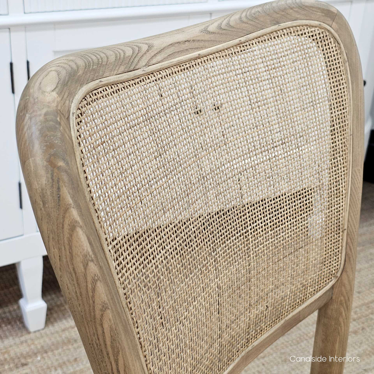 Close-up of the Noda Oak Rattan Dining Chair’s rattan backrest, capturing the delicate weave and natural variations in texture.