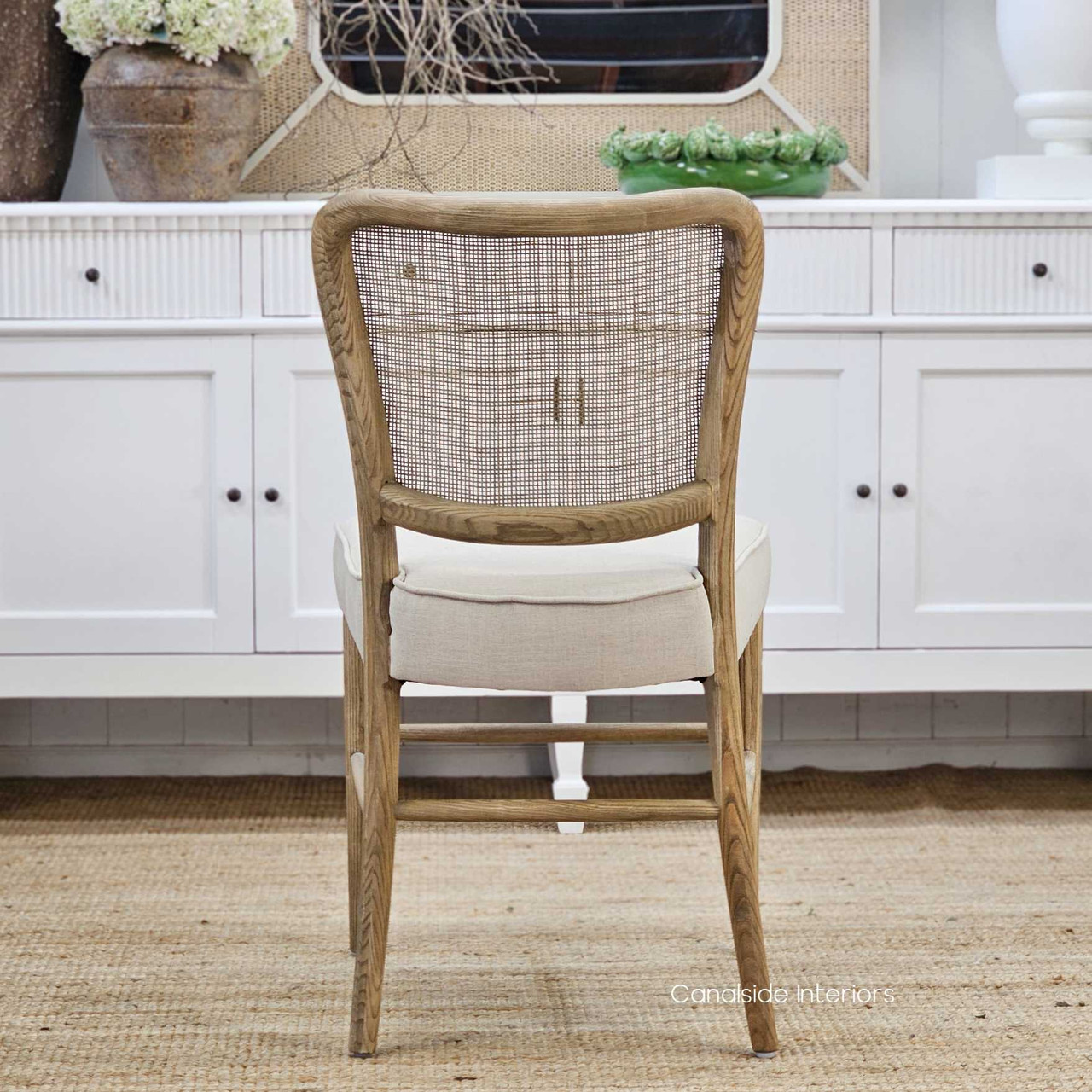 Full back view of the Noda Oak Rattan Dining Chair, emphasising the intricate handwoven rattan texture and smooth oak finish.