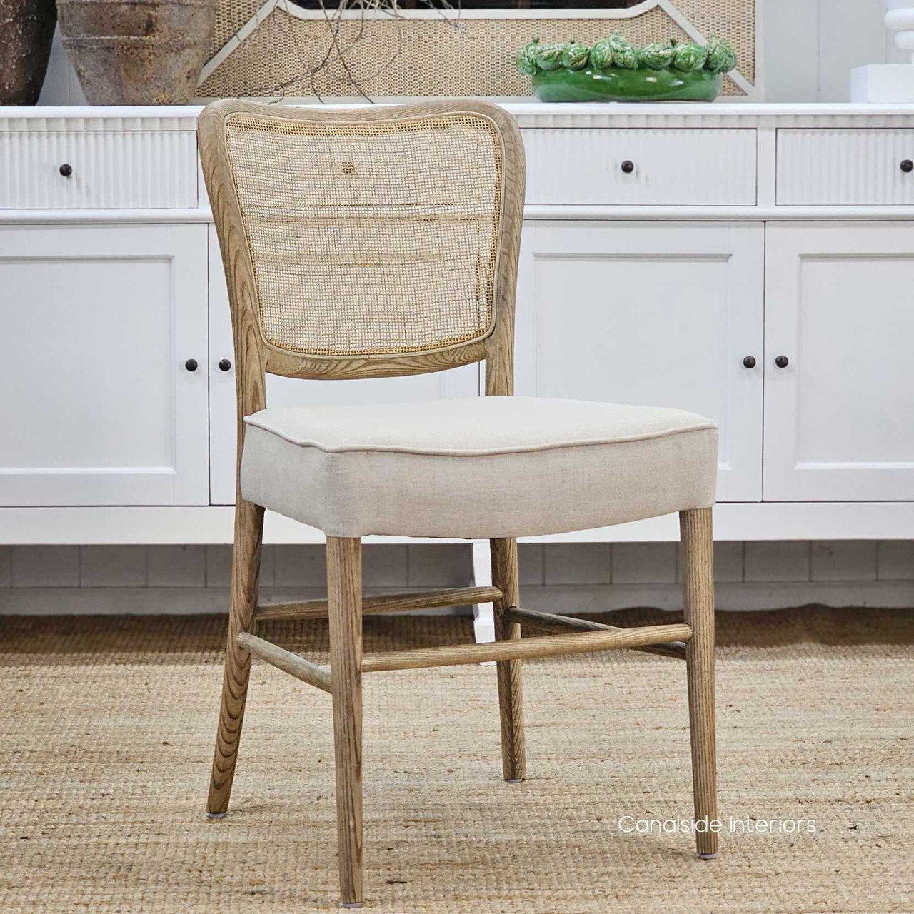 Angled profile of the Noda Oak Rattan Dining Chair, displaying its balanced proportions and seamless blend of oak and rattan materials.