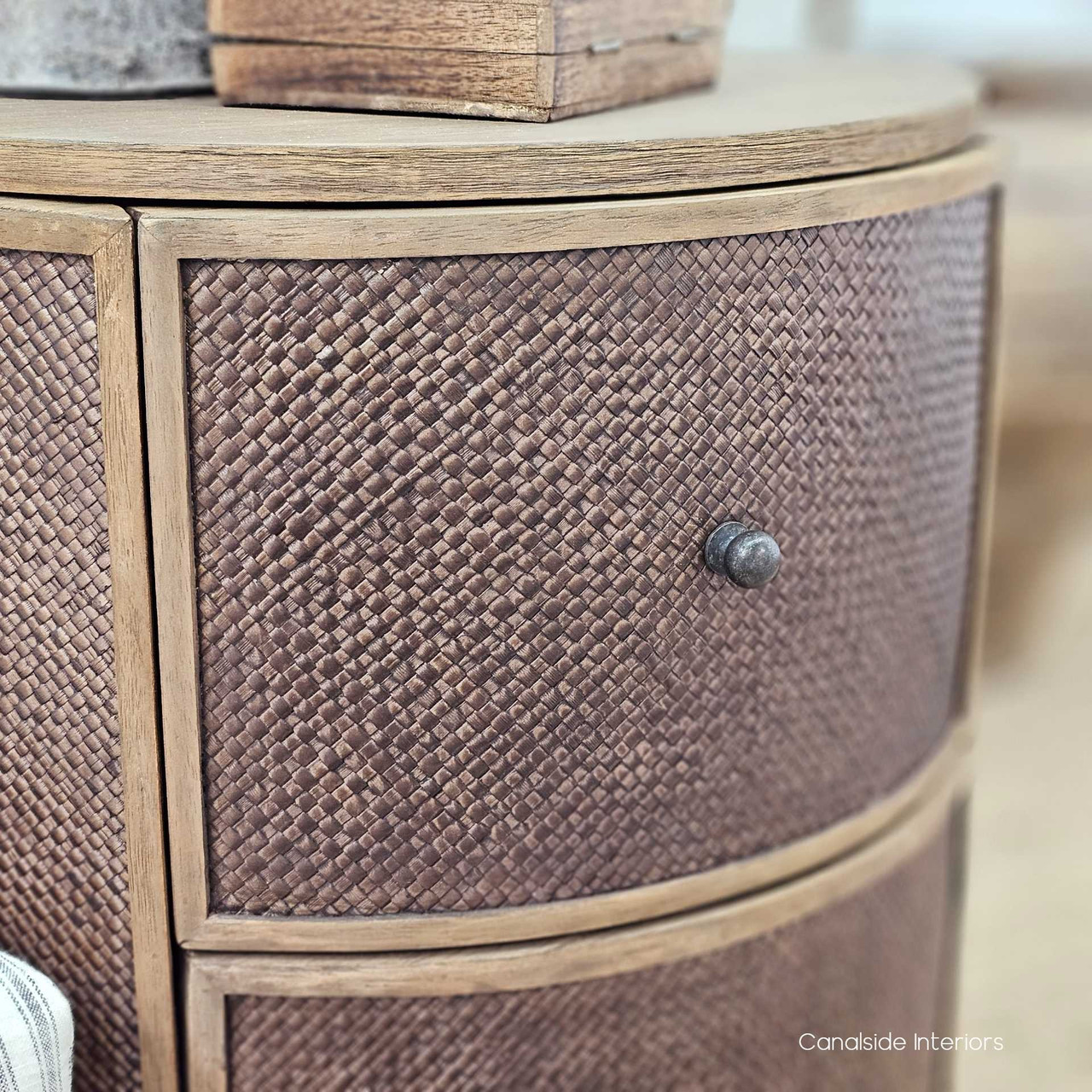 Low-angle shot of the Langston Rattan Side Table, emphasizing its bold, masculine undertones and sculptural presence.