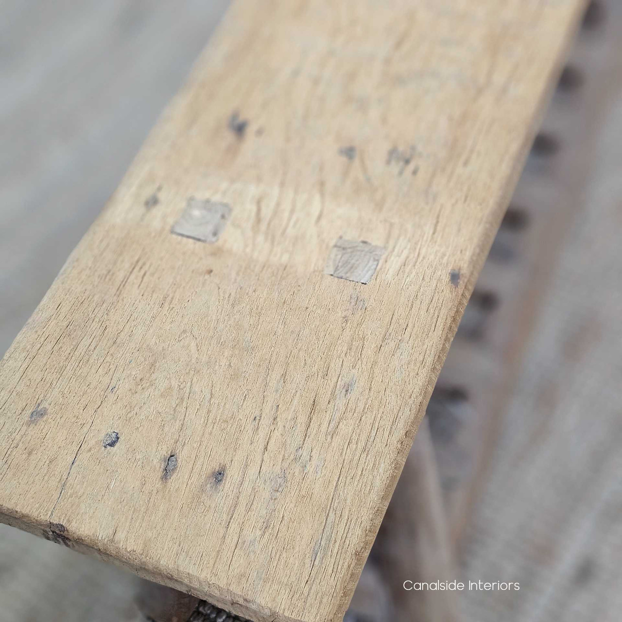 Top-down view of the Vintage Teak Bench, revealing its organic texture, rich teak finish, and spacious slatted base.