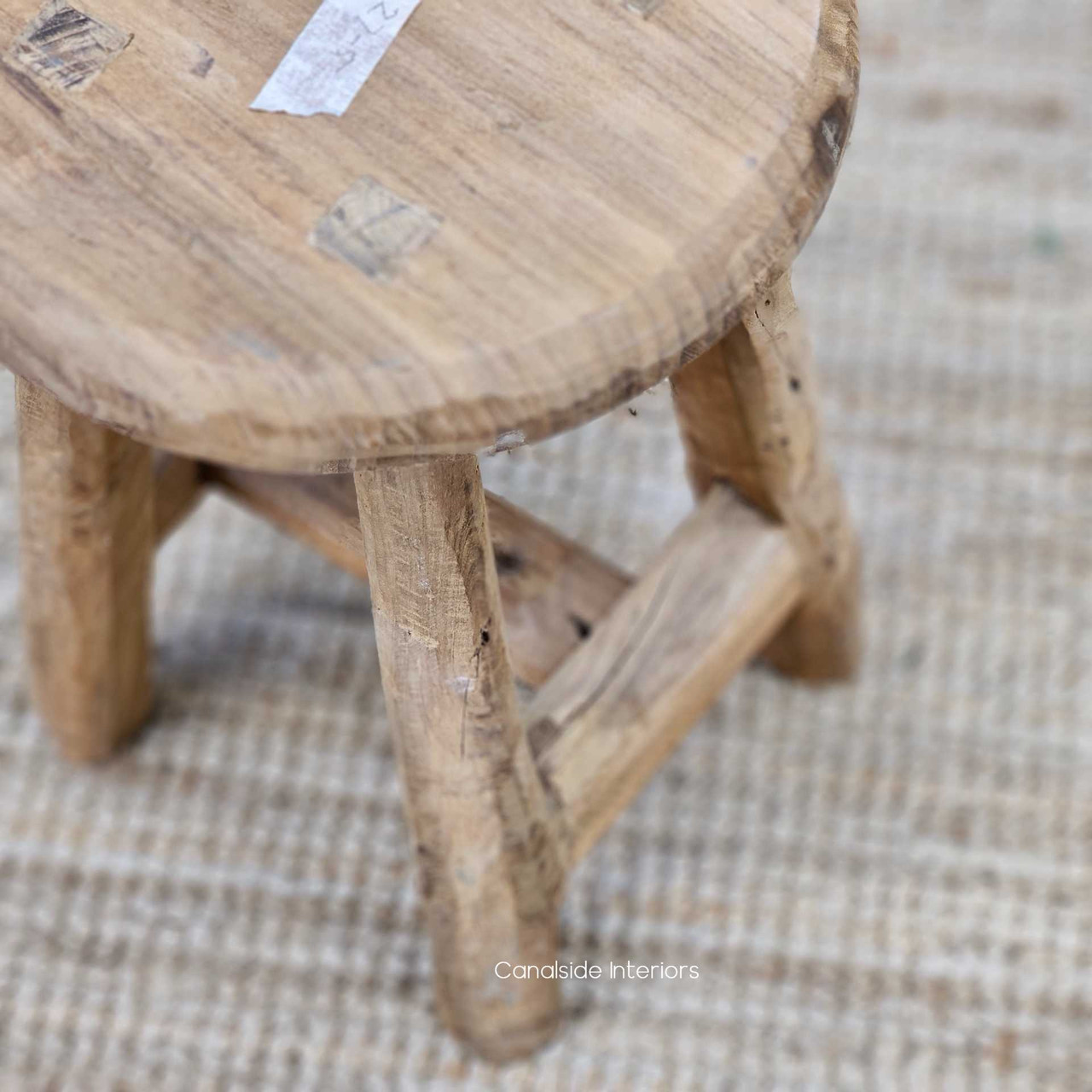 Detailed shot of the stool’s base, highlighting the thick, grounded form and handcrafted finish.