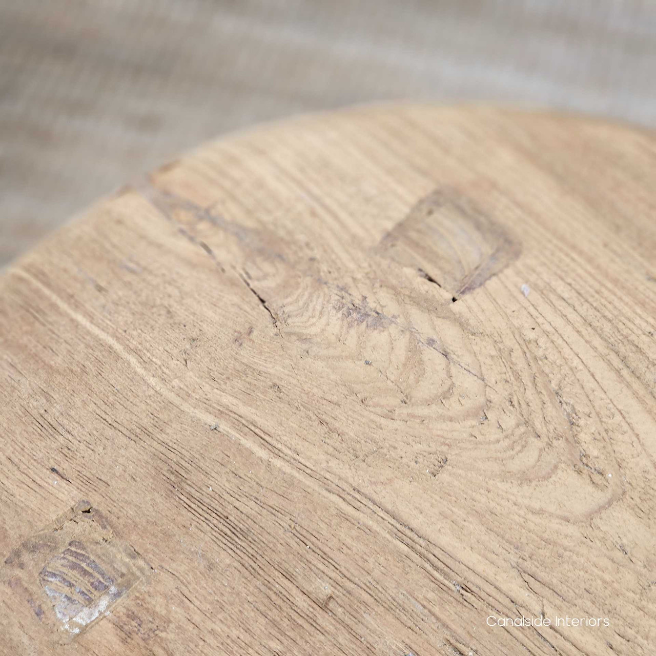 Detailed top-down view of the Vintage Teak Round Stool, highlighting the organic cracks, knots, and textures that give each piece its unique character.