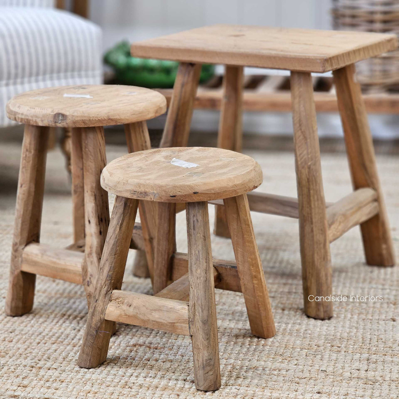 Side-by-side view of different sized Vintage Teak Round Stools, ideal for layered styling.