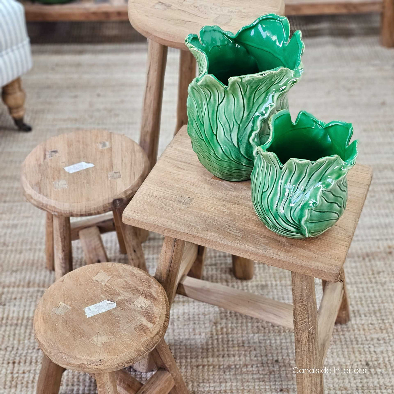 Larger round stool used as a side table, demonstrating its multipurpose function.