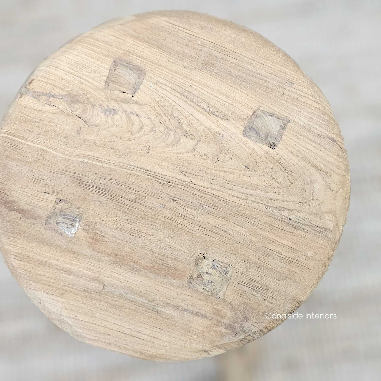 Close-up of the Vintage Teak Round Stool’s edge, displaying the rich patina and natural imperfections in the timber.
