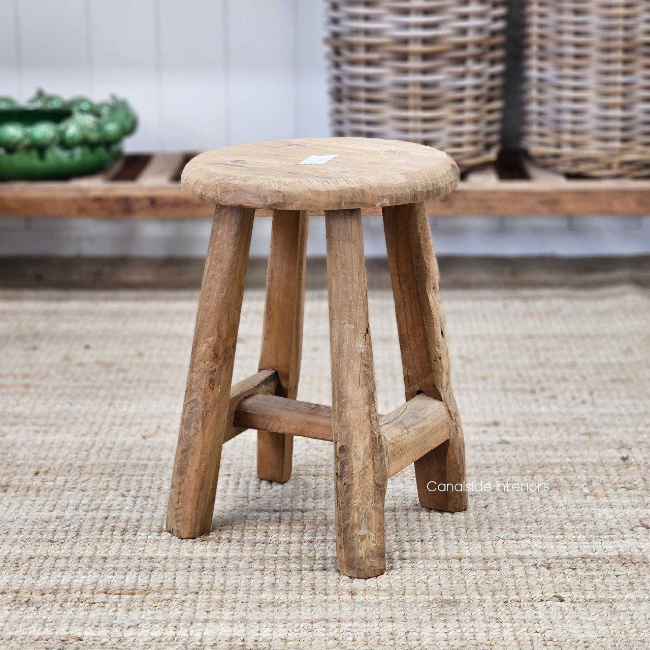 Angled front view of the Vintage Teak Round Stool, emphasizing its minimal yet bold profile.