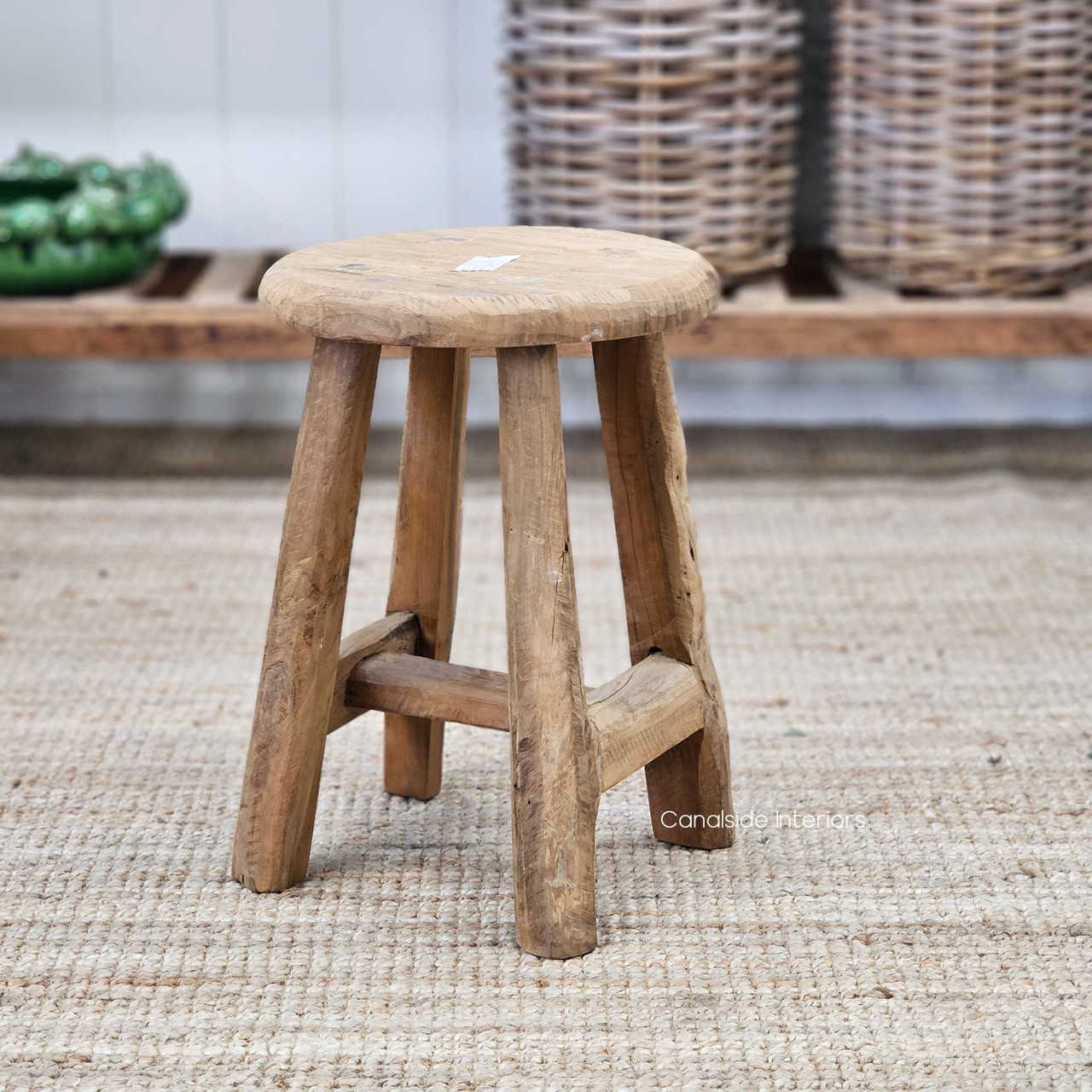 Low-angle shot of the Vintage Teak Round Stool, highlighting the solid cylindrical shape and sturdy base.