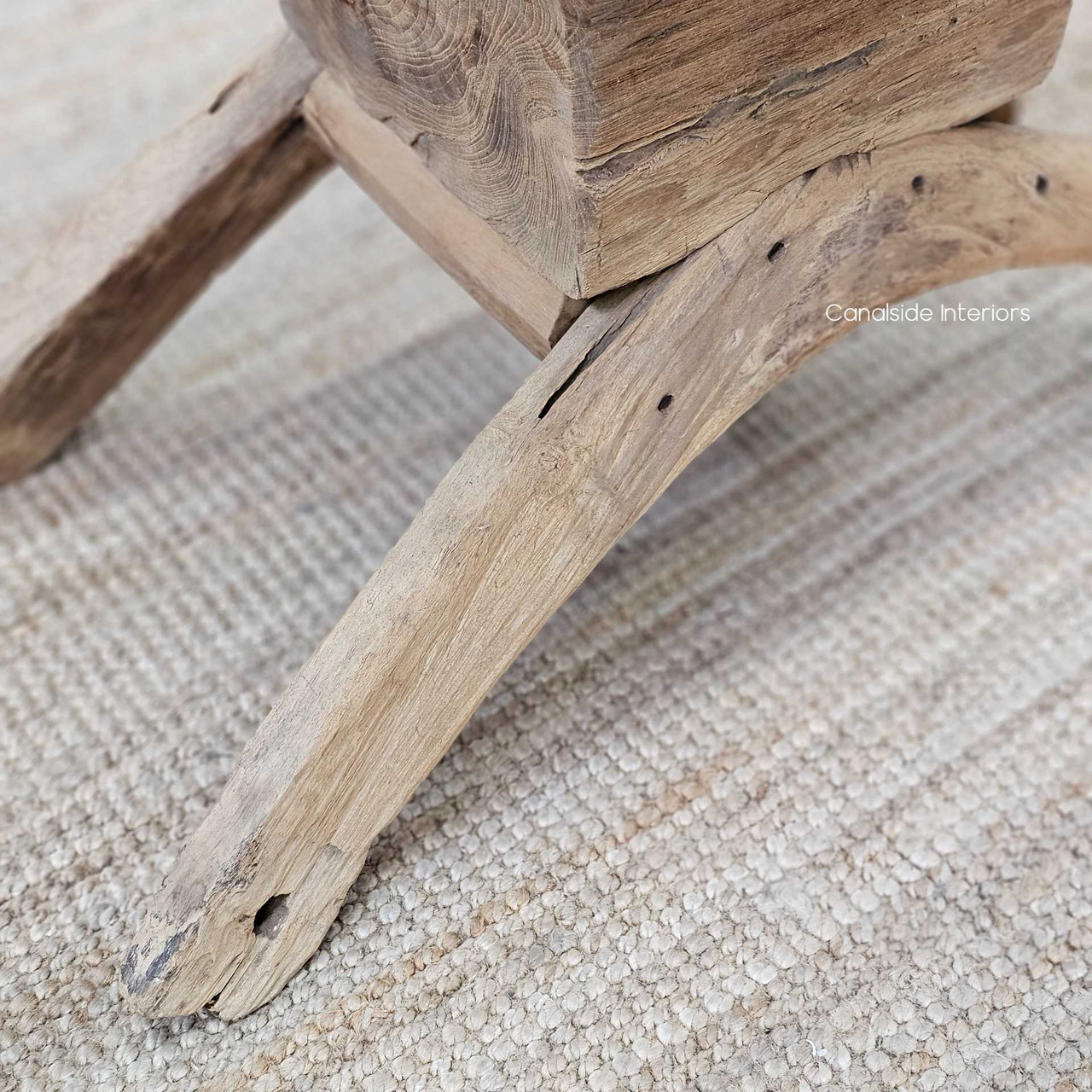 Detailed shot of the coffee table’s base, highlighting the handcrafted joinery and unique wood markings.