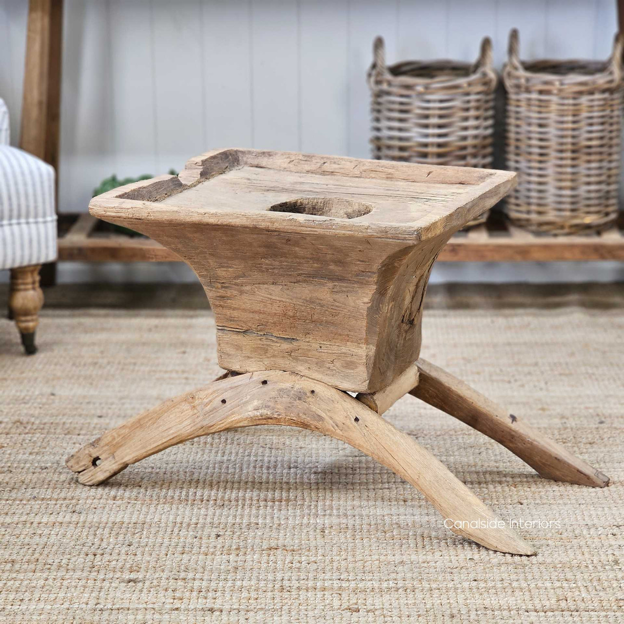 Side angle of the Vintage Teak Lumpang Coffee Table, highlighting the curved wooden legs and rustic hand-carved details.