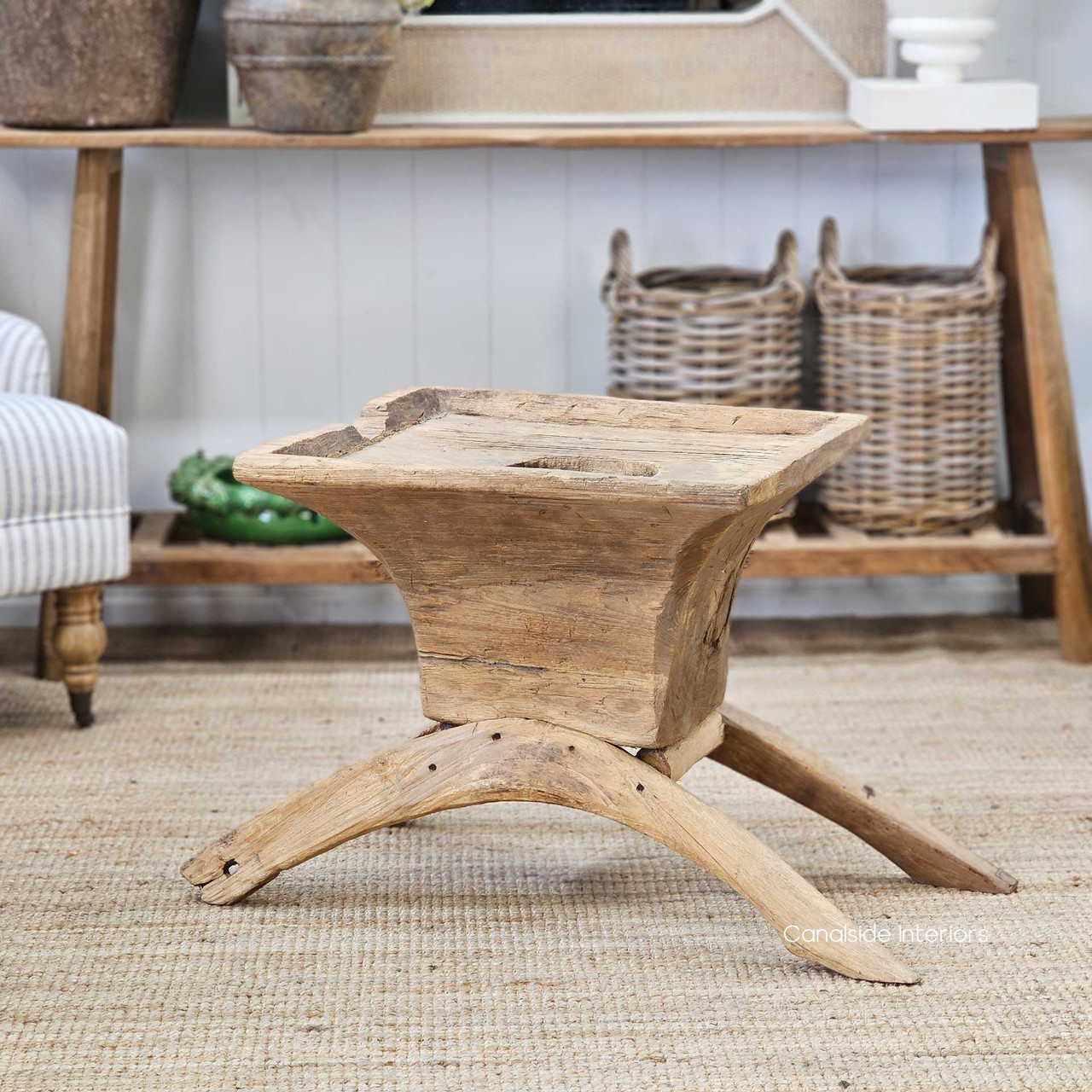 Angled shot of the coffee table in a sunlit room, emphasizing its warm teak tones and natural wood character.