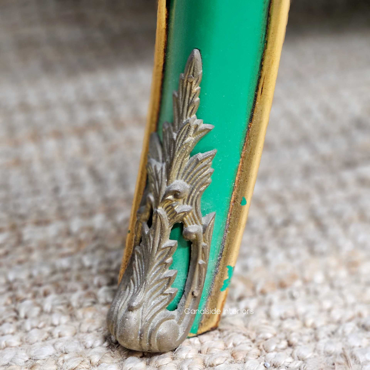 Detailed view of the scrolled foot, featuring the curved silhouette, fine trim detail, and delicate shaping.