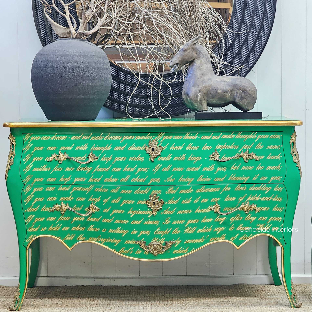 Front-facing image of the Piccini Commode, highlighting its vibrant green finish, sweeping bombe silhouette, and poetic gold script.