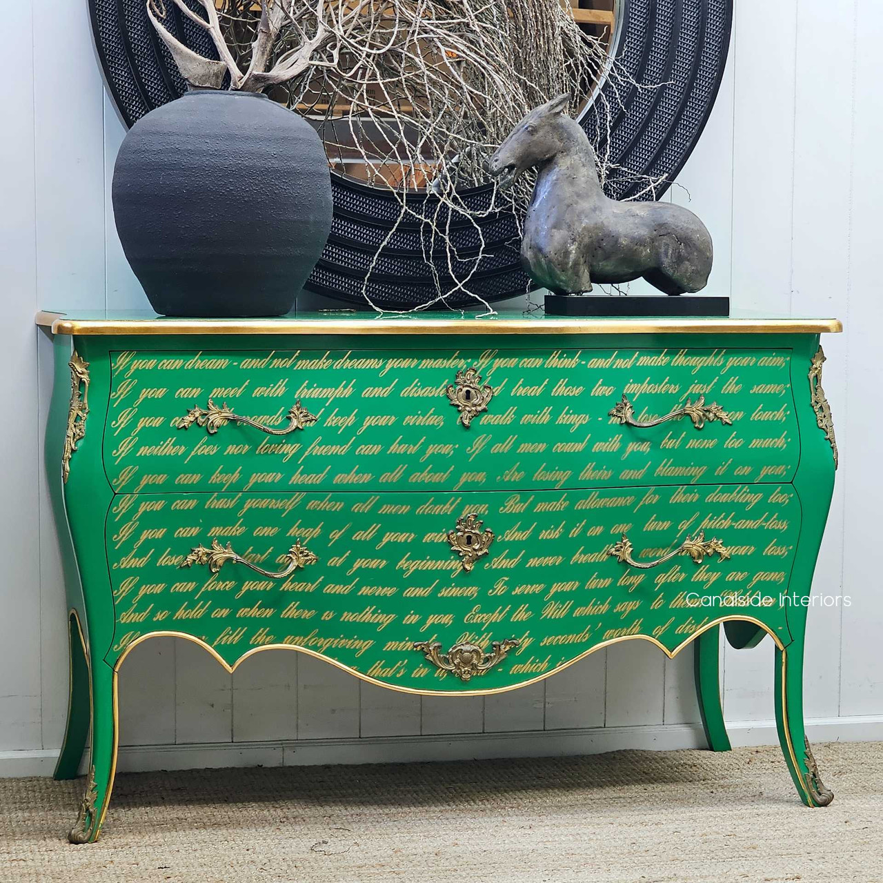Angled side view of the Piccini Commode, highlighting the bombe curves, gold trim accents, and rich texture of the script detailing.