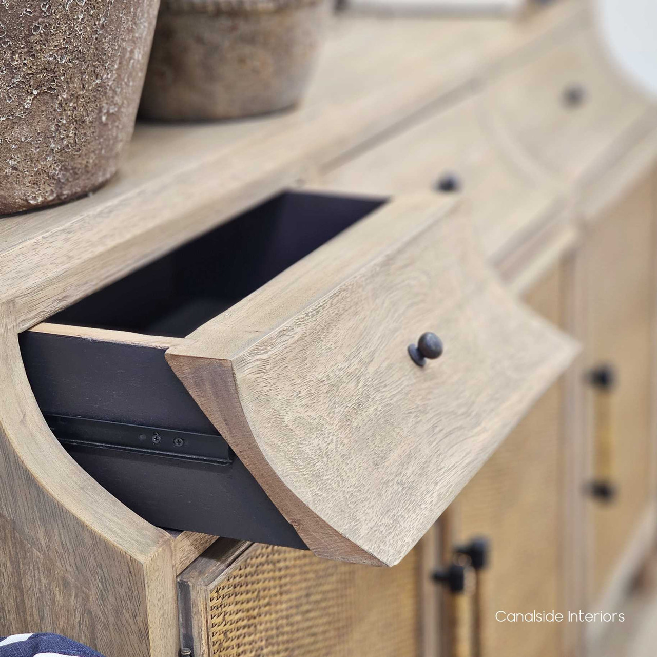 Close-up of where the drawer meets the door, showing the subtle joinery craftsmanship and metal drawer runner