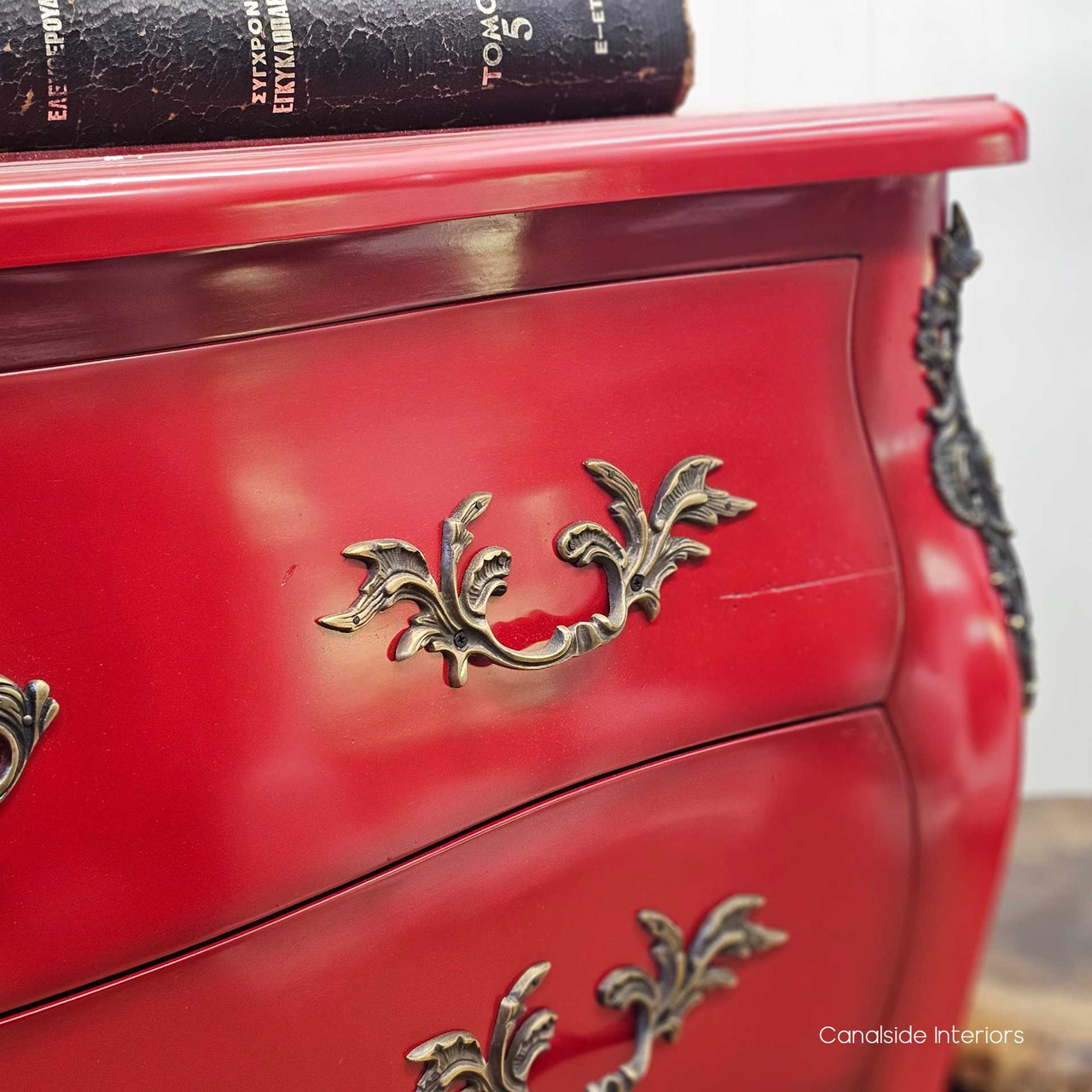 Close-up of the drawer handles, showcasing the ornate antique-bronze hardware and aged finish.