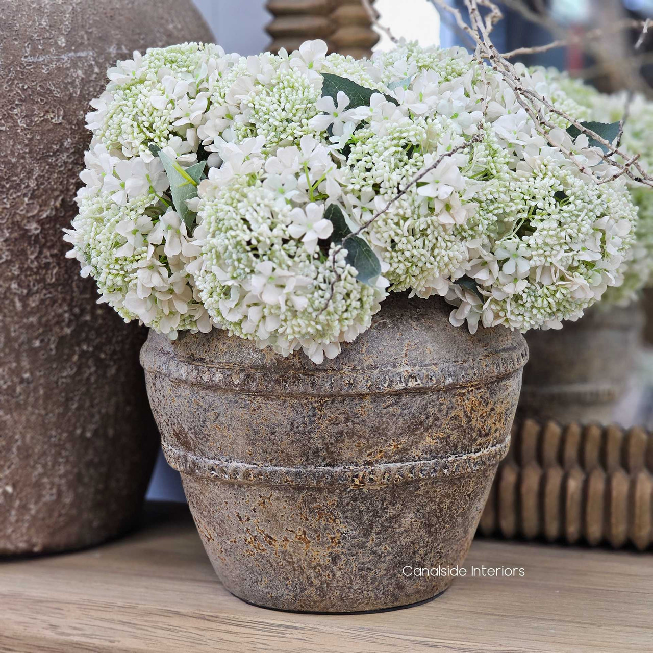 Front view of the Cordelle Vessel, showcasing its earthy textured clay surface and rope detail.