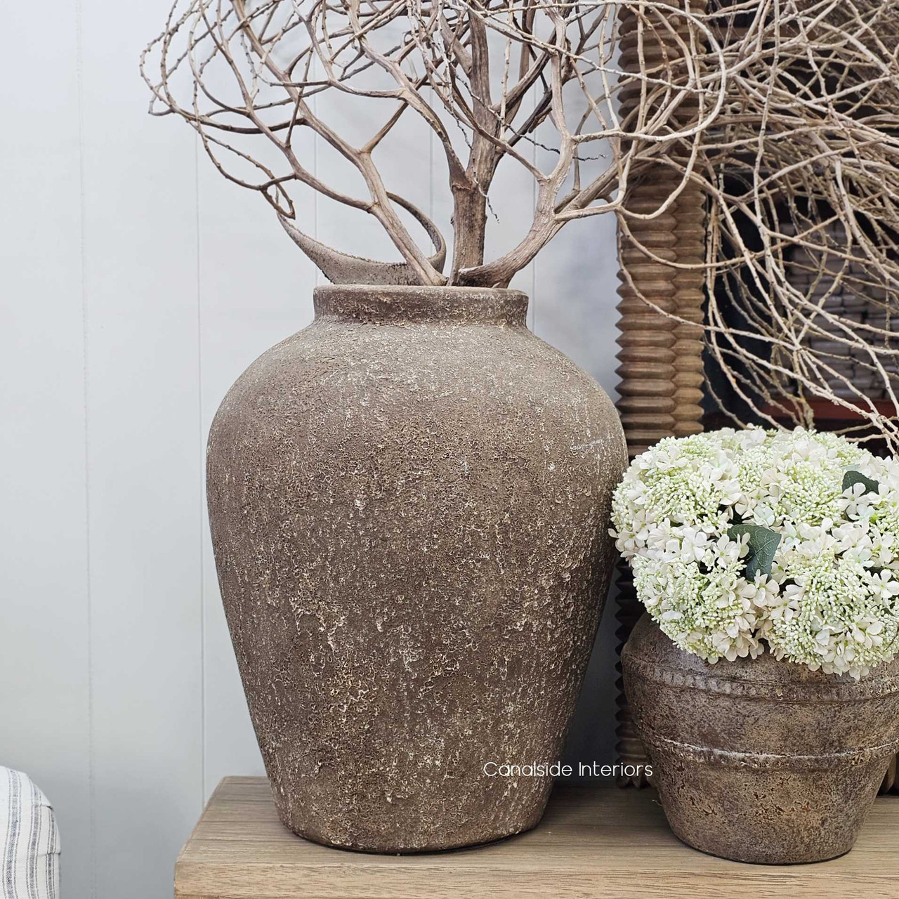 Ayara pot styled on a console with soft natural light, showcasing its earthy presence and timeless appeal.