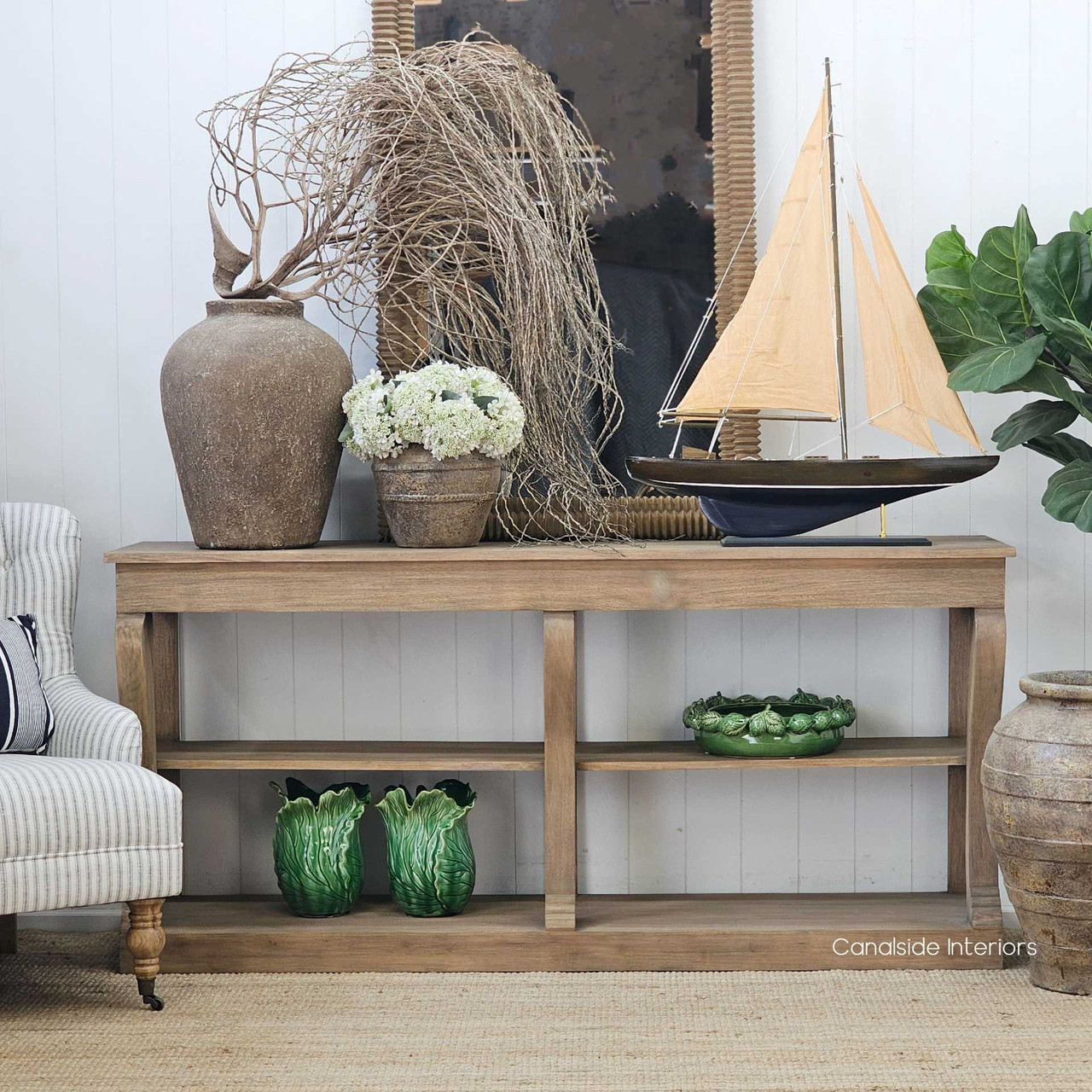 Ayara Vessel displayed on a slim natural timber console, adding sculptural weight and quiet sophistication to an entryway or hallway setting with earthy, curated charm.