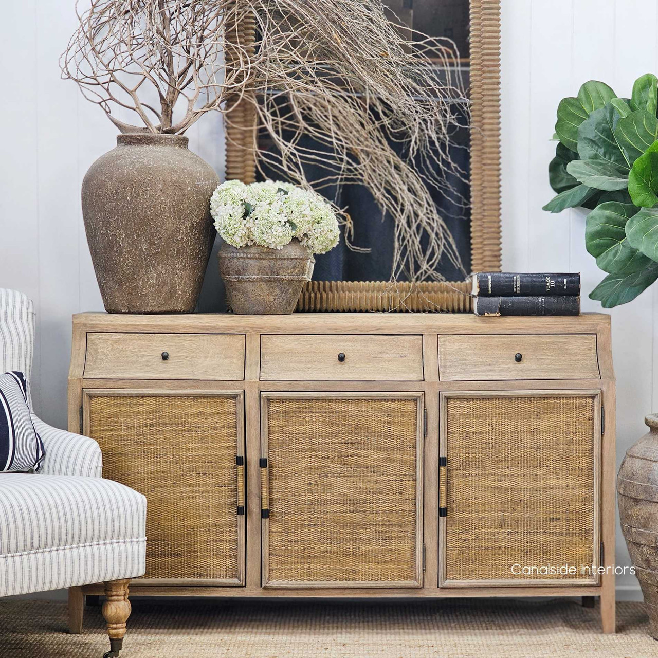 Ayara Vessel placed on a natural, organic wood sideboard, blending seamlessly with earthy textures and raw materials for a grounded, wabi-sabi inspired vignette.